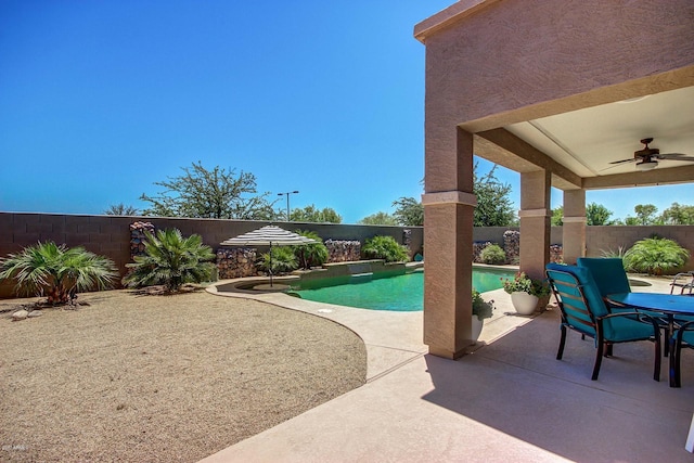 view of pool with ceiling fan and a patio area