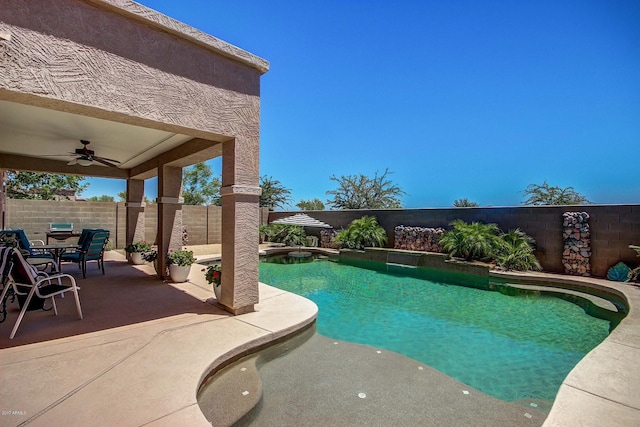 view of swimming pool featuring ceiling fan and a patio