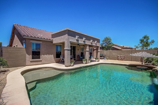 view of swimming pool featuring ceiling fan and a patio area