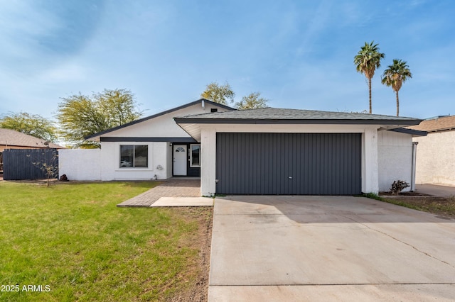 ranch-style home with a garage and a front yard