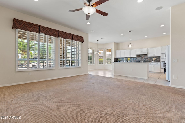 unfurnished living room featuring light tile patterned floors, recessed lighting, a ceiling fan, and light colored carpet