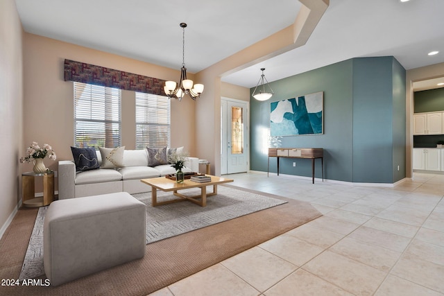 tiled living room featuring an inviting chandelier