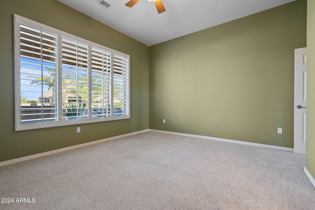 carpeted empty room featuring ceiling fan