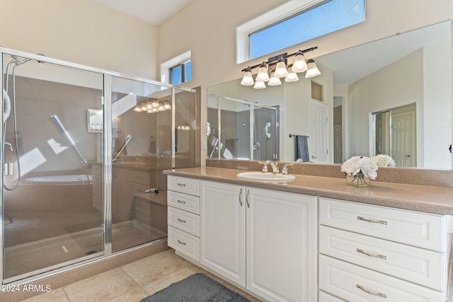 full bath featuring a stall shower, tile patterned floors, and vanity