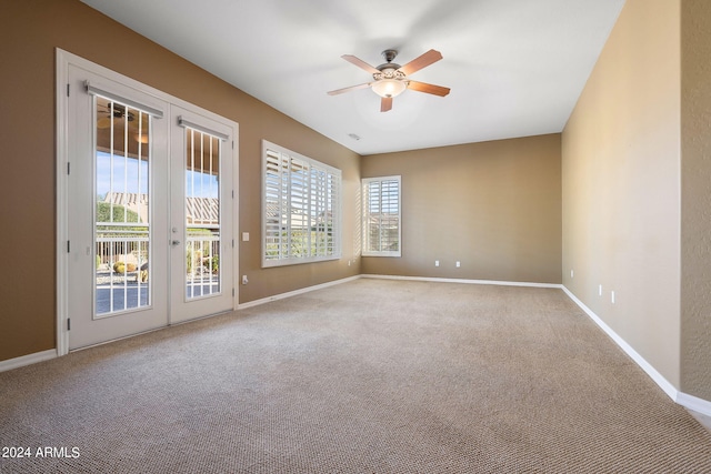 carpeted empty room with french doors and ceiling fan