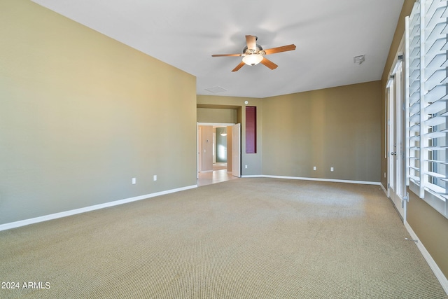 carpeted empty room featuring ceiling fan