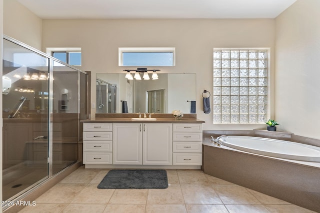 bathroom featuring a bath, vanity, a wealth of natural light, and a shower stall