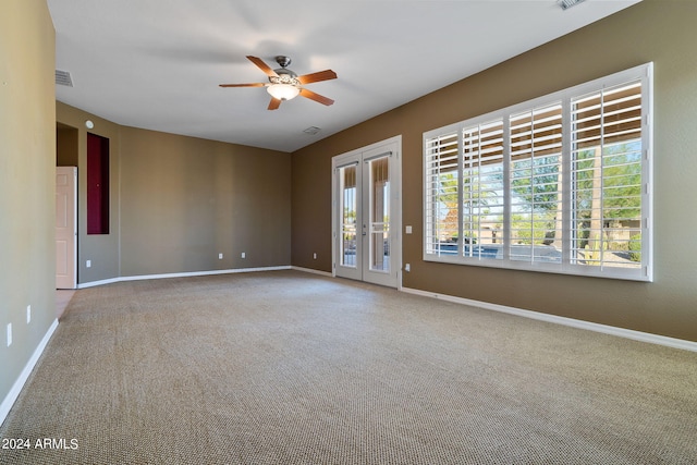 carpeted spare room featuring ceiling fan