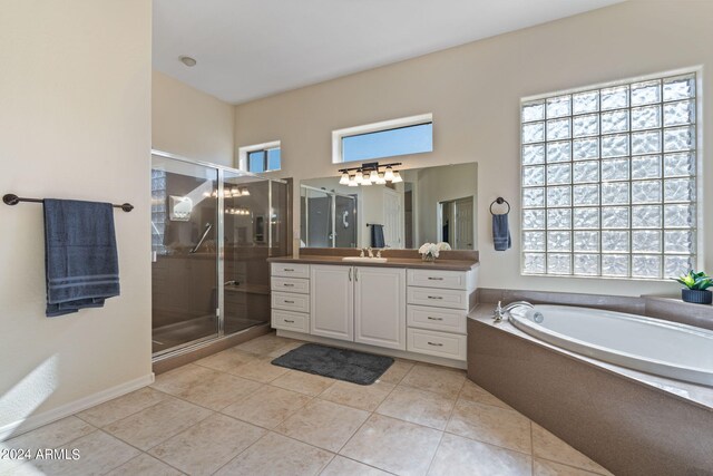 bathroom with tile patterned flooring, plenty of natural light, a shower stall, and vanity