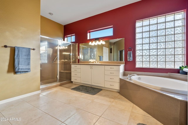 bathroom featuring tile patterned flooring, independent shower and bath, and vanity