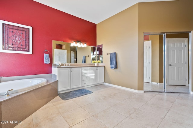 bathroom featuring vanity, a bathing tub, and tile patterned flooring