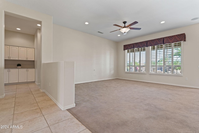 unfurnished room featuring light tile patterned floors, recessed lighting, light colored carpet, a ceiling fan, and visible vents