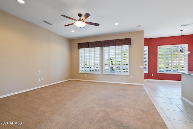 carpeted spare room featuring ceiling fan