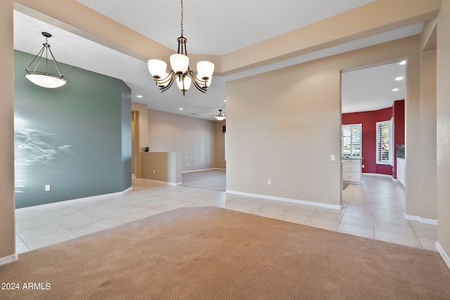 unfurnished room with ceiling fan with notable chandelier and light tile patterned floors