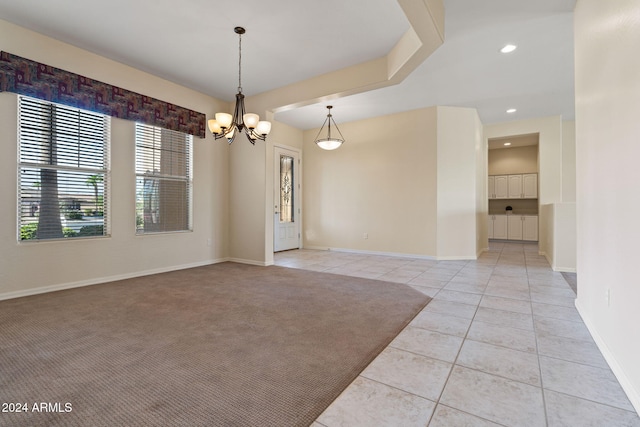 empty room featuring light tile patterned floors, recessed lighting, baseboards, and an inviting chandelier