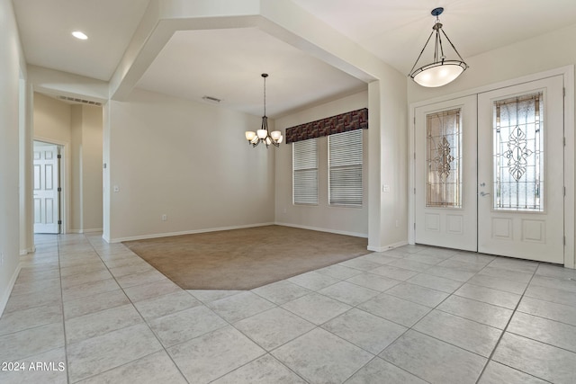 foyer entrance featuring light tile patterned floors, french doors, a notable chandelier, and light colored carpet