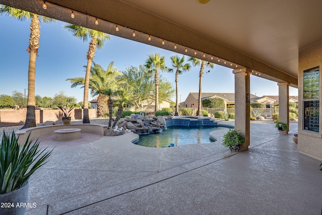 view of pool with a patio area, a fenced backyard, and a pool with connected hot tub