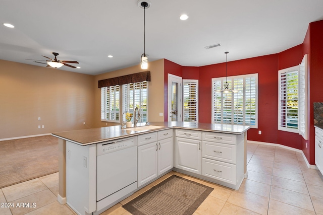 kitchen with ceiling fan, white dishwasher, an island with sink, and sink