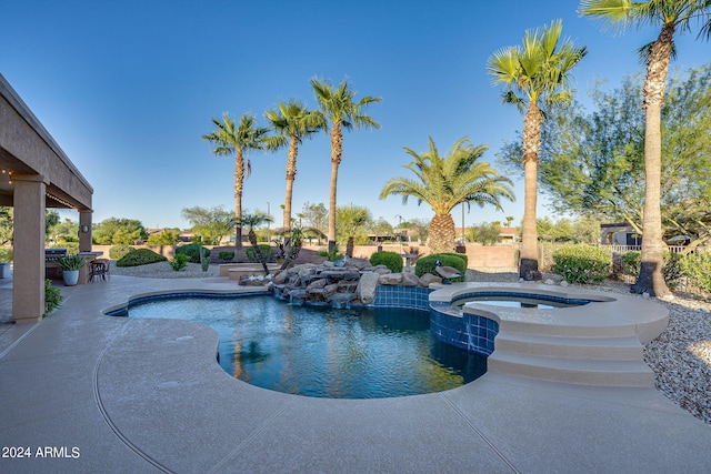 view of swimming pool with a patio and an in ground hot tub