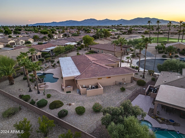 aerial view at dusk featuring a residential view and a mountain view