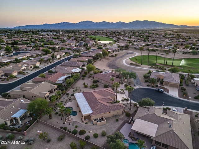 aerial view at dusk featuring a residential view and a mountain view