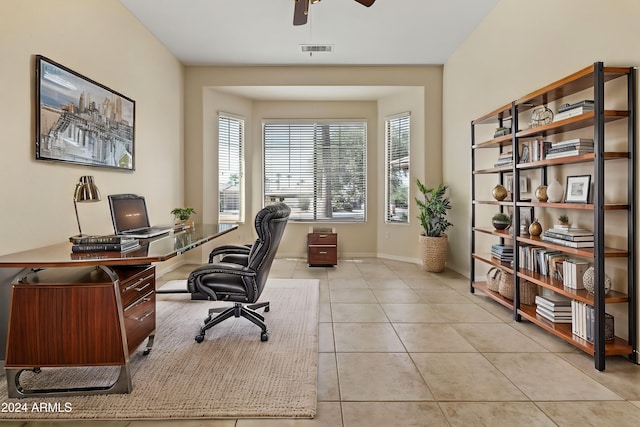 office area with baseboards, visible vents, a ceiling fan, and light tile patterned flooring