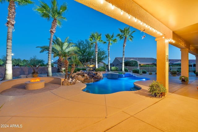 view of pool featuring a patio, an outdoor fire pit, a fenced backyard, and a pool with connected hot tub