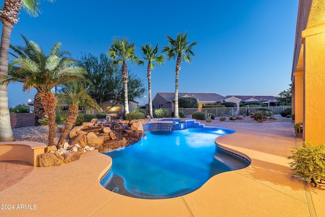 view of swimming pool featuring a patio area, a fenced backyard, and a pool with connected hot tub