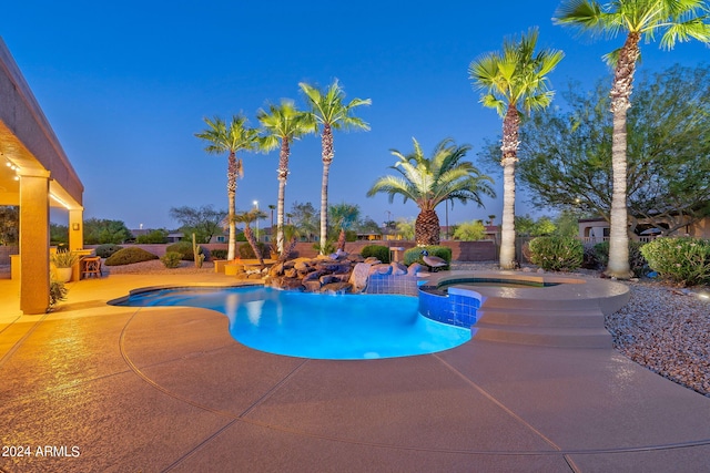 view of swimming pool with a patio and a pool with connected hot tub