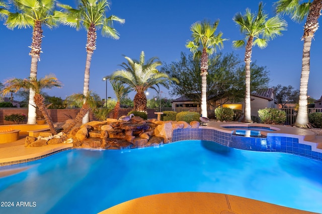 view of pool featuring an in ground hot tub, fence, and a fenced in pool