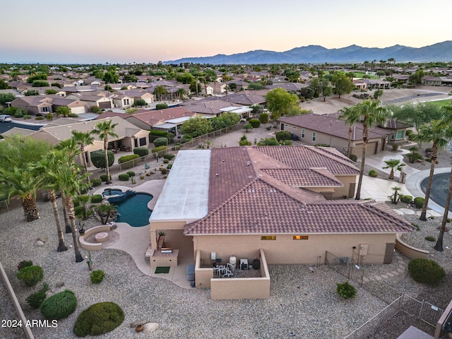 aerial view at dusk featuring a mountain view