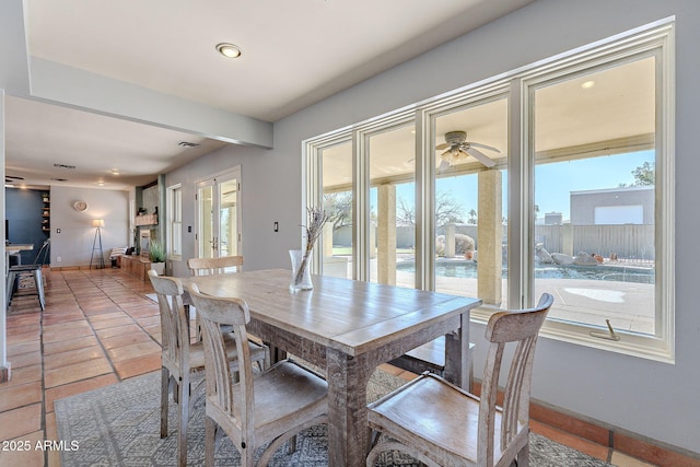 dining room featuring ceiling fan and a wealth of natural light