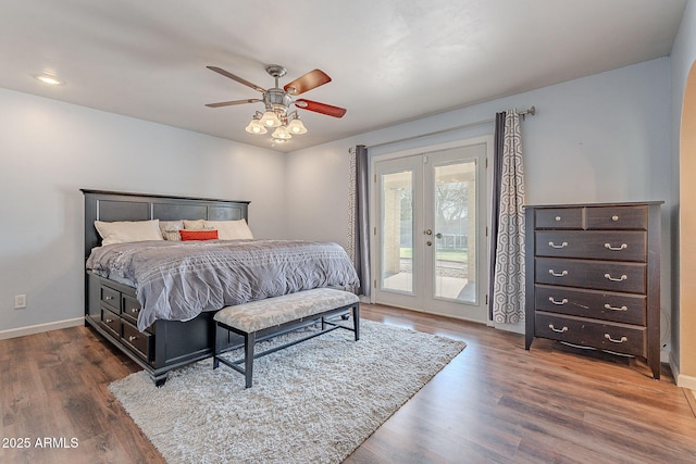 bedroom featuring access to exterior, dark wood-type flooring, french doors, and ceiling fan