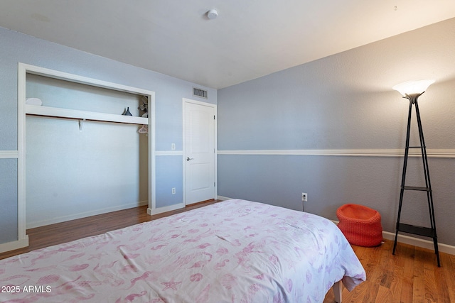 bedroom featuring wood-type flooring and a closet