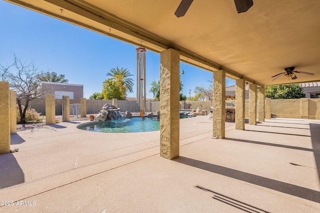 view of pool with pool water feature, ceiling fan, and a patio area