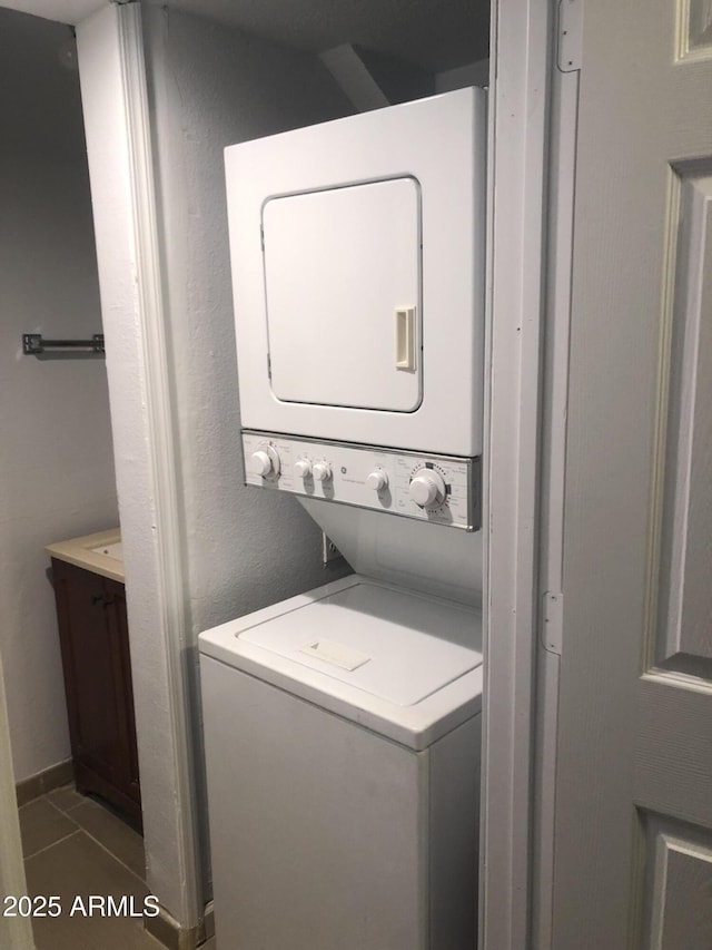 12445 N 21st Ave Unit 31, Phoenix, AZ 85029 - laundry room featuring stacked washer / dryer and tile patterned flooring
