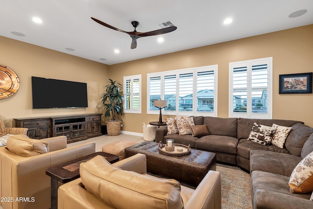 living room featuring ceiling fan and plenty of natural light