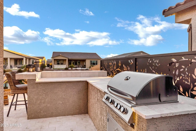 view of patio featuring a grill, exterior bar, and area for grilling