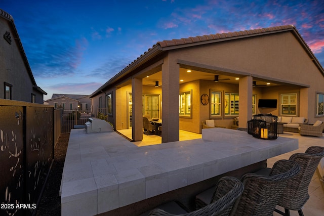 exterior space featuring a patio area, an outdoor bar, and ceiling fan