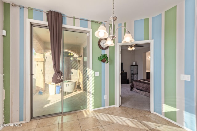 interior space with tile patterned floors and ceiling fan with notable chandelier