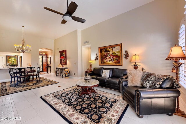 living room featuring ceiling fan with notable chandelier, a healthy amount of sunlight, and light tile patterned flooring