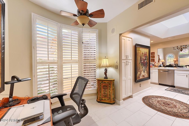 home office with a wealth of natural light, ceiling fan, and light tile patterned floors