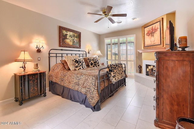 tiled bedroom featuring ceiling fan