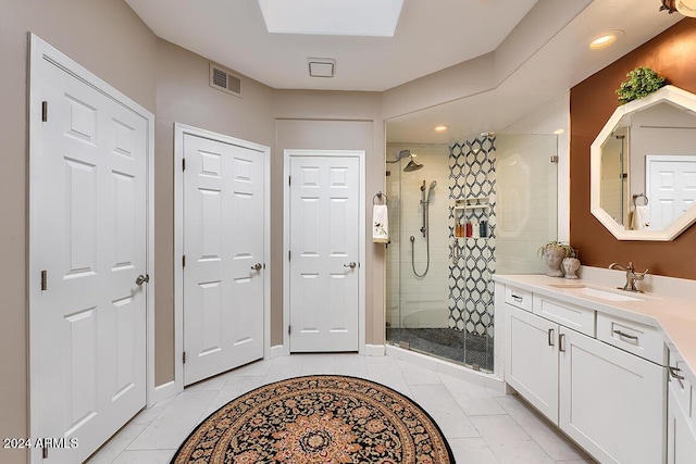 bathroom featuring tile patterned flooring, vanity, and a shower with shower door