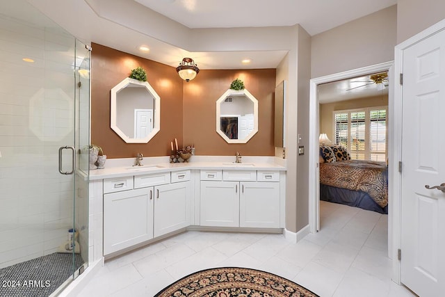 bathroom featuring tile patterned flooring, vanity, and a shower with door