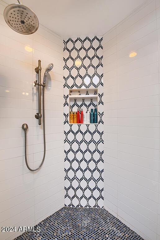 bathroom with a tile shower