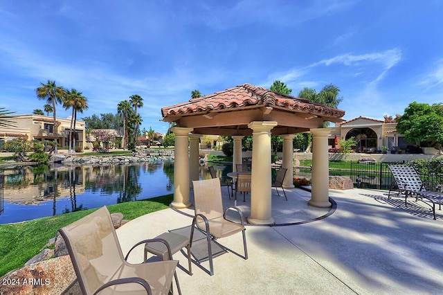 view of patio / terrace with a gazebo and a water view