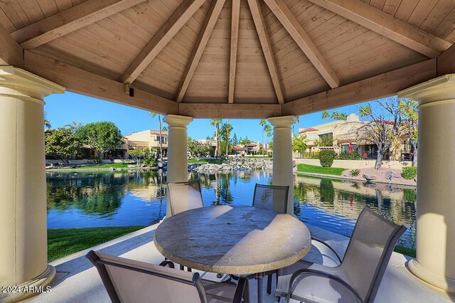 view of patio with a gazebo and a water view