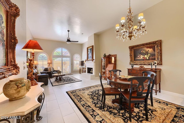 tiled dining area with ceiling fan with notable chandelier