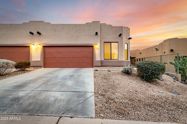 adobe home featuring a garage